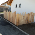Lärchenzaun mit senkrechten Brettern kreativ zugeschnitten